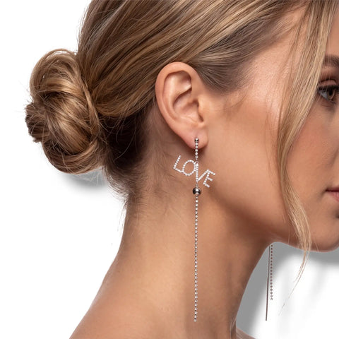 Silver asymmetric LOVE earrings with rhinestone fringe chains, long shoulder-duster drops and post backs