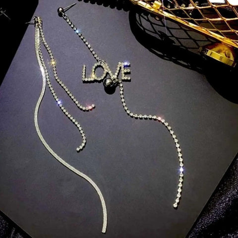 Silver asymmetric LOVE earrings with rhinestone fringe chains, long shoulder-duster drops and post backs
