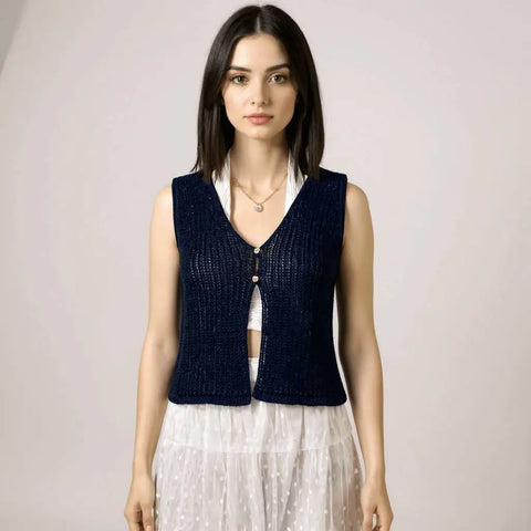 navy cropped knit vest layered over white halter top