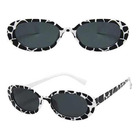 Women’s vintage-inspired oval sunglasses with black and white animal print and stylish summer look.