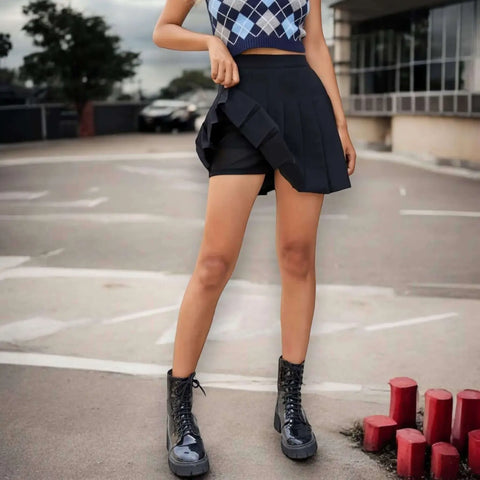 Solid pleated mini skirt in black with built-in shorts, high waist fit, and permanent pleats. Available in multiple colors. Y2K, schoolgirl, and punk-inspired.