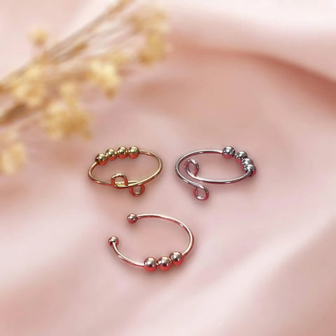 Stackable beaded open rings in silver, gold, copper, and rose gold with spinning fidget beads and open adjustable band design