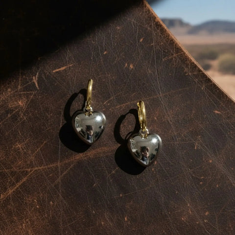 Gold-tone hoop earrings with silver-tone puffy bubble heart charms and hinged clip closures