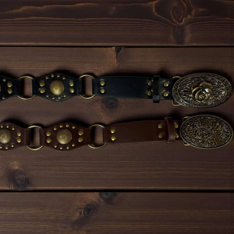 Western floral buckle medallion wide belt in brown or black vegan leather with antique gold studs rivets and O-rings, adjustable buckle closure, 1 3/8 inch strap width