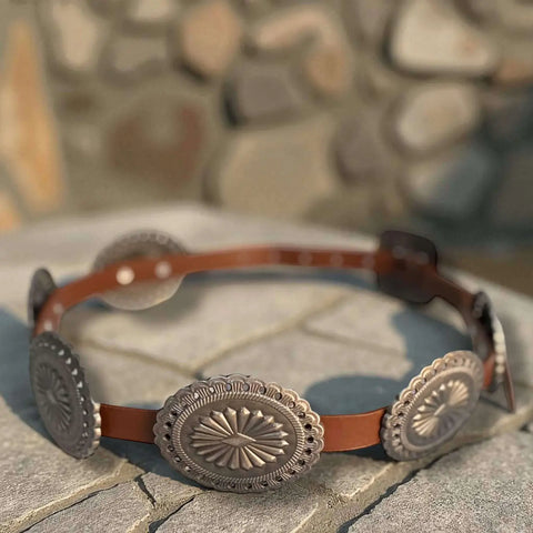 Reddish Brown Western Leather Silver Concho Buckle Belt flat lay on concrete