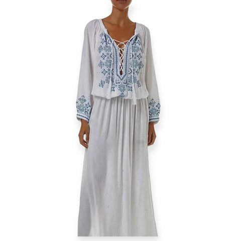 model wearing White Blue Embroidered Kaftan Dress with lace-up tassel neckline, long sleeves, smocked waist, and side splits