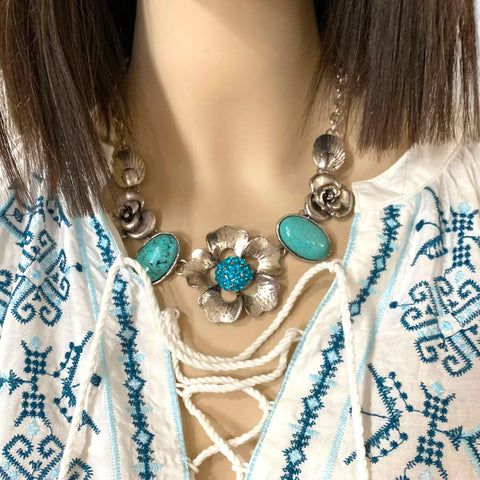 neckline of White Blue Embroidered Kaftan Dress with lace-up tassel neckline, long sleeves, smocked waist, and side splits