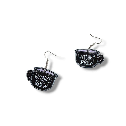 Witches Brew Acrylic Tea Cup Earrings in black with double-sided pink and white lettering and fish hook dangles flat lay