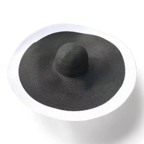 black with white trim Women’s Oversized Brim Straw Sun Hat with dramatic 10-inch asymmetrical brim and woven straw beach style
